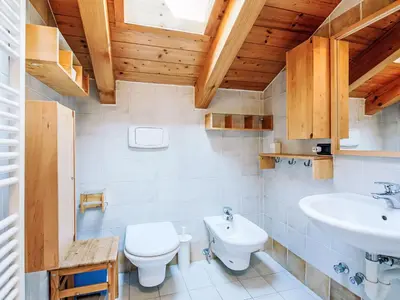 a bathroom with a toilet and a sink at Apartment Condominio Parco degli abeti by Interhome in Canazei
