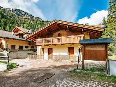 a building with a balcony on the side of it at Apartment Condominio Parco degli abeti by Interhome in Canazei
