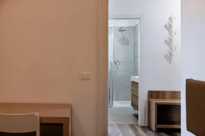 a kitchen with wooden cabinets and a microwave at Roma Ariston 10 in Bolzano