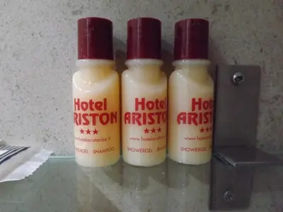 three bottles of hot sauce sitting on top of a table at Roma Ariston 10 in Bolzano