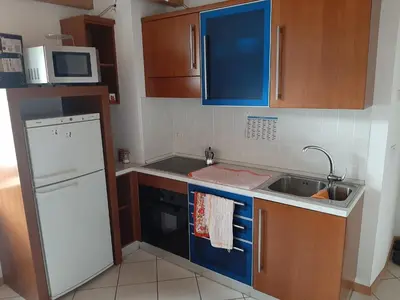 a small kitchen with a sink and a refrigerator at Accogliente Bilocale in centro a Predazzo in Predazzo
