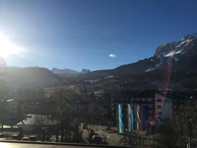 a view of a city with mountains in the background at Lovely 2 bedroom flat in Corso Italia with parking in Cortina dʼAmpezzo