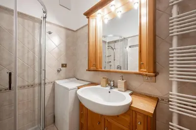 a bathroom with a sink and a toilet and a shower at Lovely 2 bedroom flat in Corso Italia with parking in Cortina dʼAmpezzo
