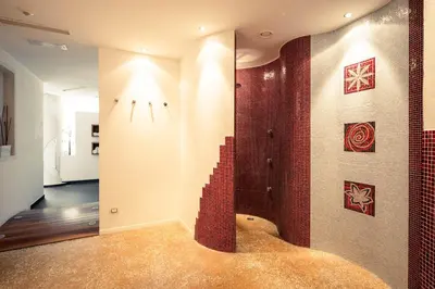 a bathroom with a shower with red tiles at Garni Jasmin in Kastelruth