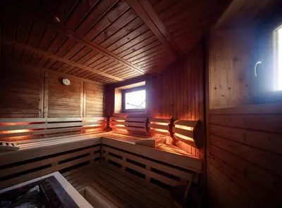 an inside of a wooden sauna with a window at Garni Jasmin in Kastelruth