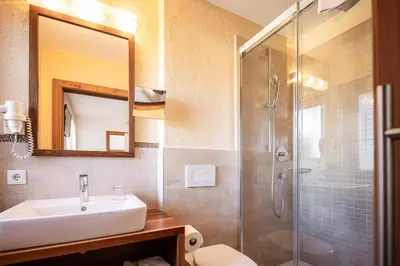a bathroom with a sink and a shower at Garni Jasmin in Kastelruth