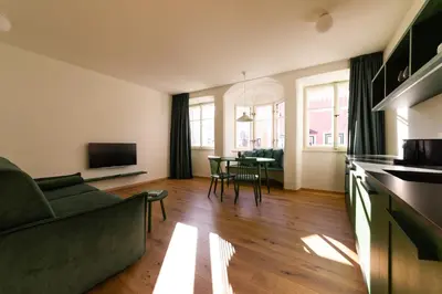 a living room with a couch and a table at Casa Fellin Guesthouse in Vipiteno