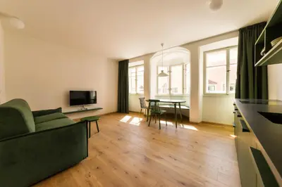 a living room with a couch and a table at Casa Fellin Guesthouse in Vipiteno