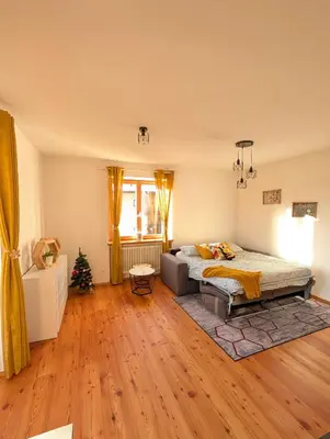 a bedroom with a bed and a christmas tree at Appartamento LA REGINA un dolce rifugio tra api e natura in Tret
