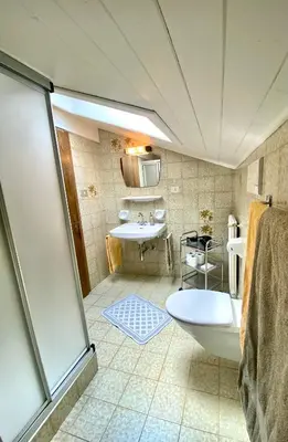 a bathroom with a tub and a sink at Appartement Primula - Haus Midi in Marlengo