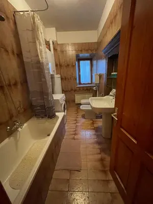 an empty hallway with white walls and wood floors at Casa vacanza predaia in Taio
