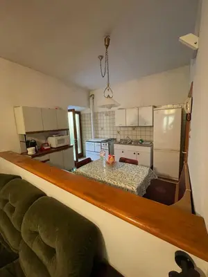 a kitchen with a table and a dining room at Casa vacanza predaia in Taio