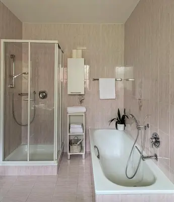a bathroom with a shower and a tub and a sink at Urlaub auf dem Bauernhof Schmidhof - große Terrasse, Pool und beste Lage in Caldaro