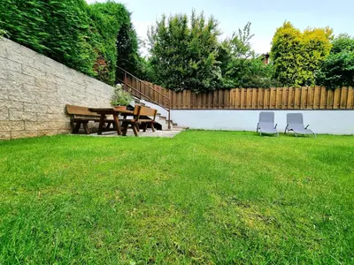 a patio with a table and chairs in a yard at Urlaub auf dem Bauernhof Schmidhof - große Terrasse, Pool und beste Lage in Caldaro