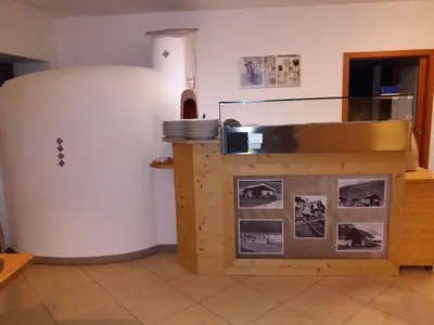a kitchen with a large refrigerator in a room at Gasthof Alpenrose - Mühleben in Sarntal