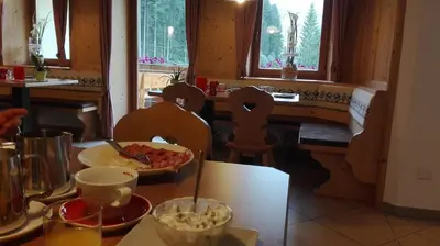 a kitchen with a table with a bowl of food at Gasthof Alpenrose - Mühleben in Sarntal