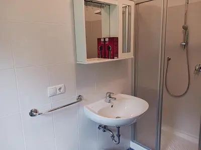 a bathroom with a sink and a shower at Gasthof Alpenrose - Mühleben in Sarntal