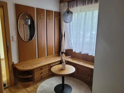 a dressing room with a chair and a mirror at Ferienwohnung Pfitschtal in San Giacomo Val di Vizze