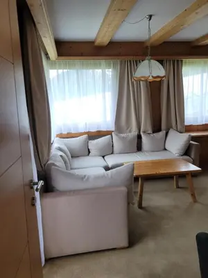 a living room with a white couch and a table at Ferienwohnung Pfitschtal in San Giacomo Val di Vizze