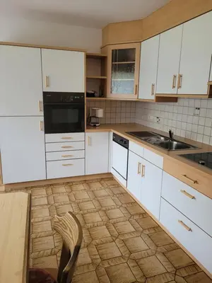 a kitchen with white cabinets and a sink at Ferienwohnung Pfitschtal in San Giacomo Val di Vizze