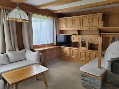 a living room with a couch and a tv at Ferienwohnung Pfitschtal in San Giacomo Val di Vizze