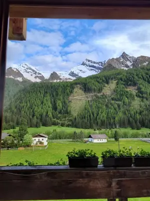 a view of a mountain range from a window at Ferienwohnung Pfitschtal in San Giacomo Val di Vizze
