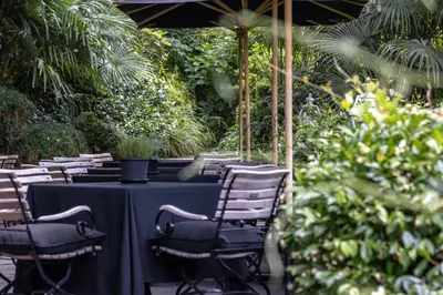 a table with a black table cloth and chairs at Hotel Villa Irma in Merano
