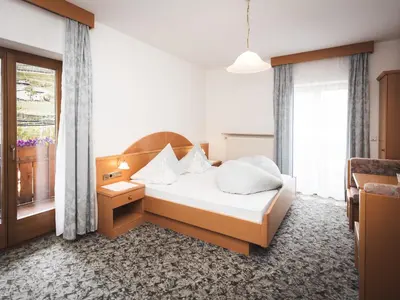 a hotel room with a bed and a window at Prissianerhof in Tesimo