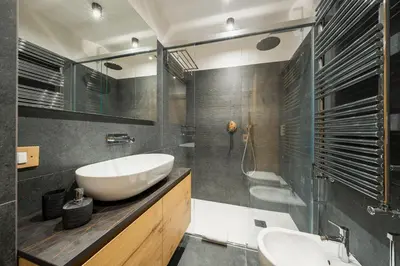 a bathroom with a sink and a mirror and a tub at Chalet Belvedere - Dolomiti Skyline in Cortina dʼAmpezzo