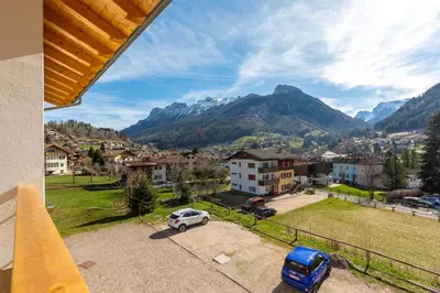 a view from a balcony of a town with mountains at Villa Maria - Appartamento vista montagna in Moena