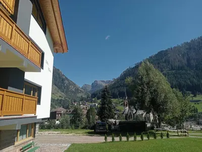 a truck parked in a parking lot next to a building at Villa Maria - Appartamento vista montagna in Moena