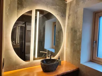 a bathroom with a round sink in front of a mirror at So close to Sellaronda lifts! in Campitello di Fassa