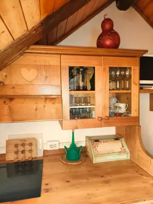 a kitchen with wooden cabinets and an apple on top at So close to Sellaronda lifts! in Campitello di Fassa