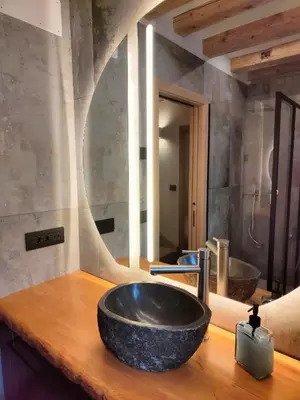 a bathroom with a black sink in front of a mirror at So close to Sellaronda lifts! in Campitello di Fassa