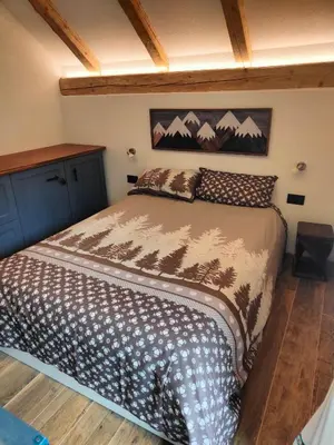 a bedroom with a large bed in a room at So close to Sellaronda lifts! in Campitello di Fassa