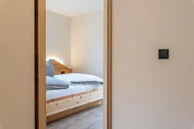a mirror reflection of a bed in a bedroom at Villa Lara Zirbe in Castelrotto