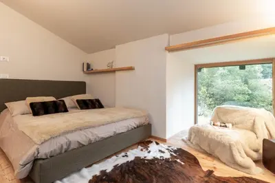 a bedroom with a large bed and a window at Villa Speronella in San Martino di Castrozza