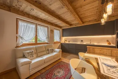 a living room with a couch and a table at Incantevole appar chalet nuovo in Borca di Cadore