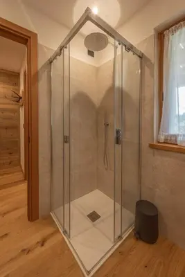 a shower with a glass enclosure in a room at Incantevole appar chalet nuovo in Borca di Cadore