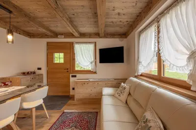 a living room with a couch and a table at Incantevole appar chalet nuovo in Borca di Cadore