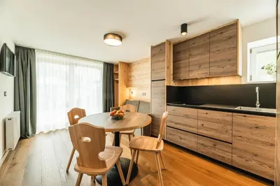 a bar in a room with wooden walls at Hotel Daniel Apartments in Selva