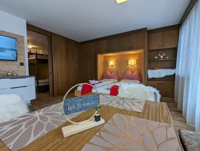 a bedroom with a large bed with a sign on it at Residence Pfeifhofer in Campo Tures