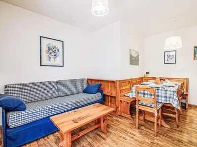 a living room with a couch and a table at Apartment Condominio Val di Fassa-2 by Interhome in Alba di Canazei