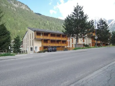 a large building on the side of a road at Apartment Condominio Val di Fassa-2 by Interhome in Alba di Canazei