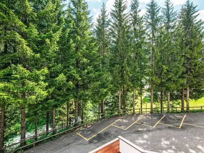 an empty parking lot with trees in the background at Apartment Condominio Val di Fassa-2 by Interhome in Alba di Canazei