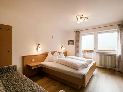 a hotel room with two beds and a window at Apartment Ornella-3 by Interhome in Ortisei