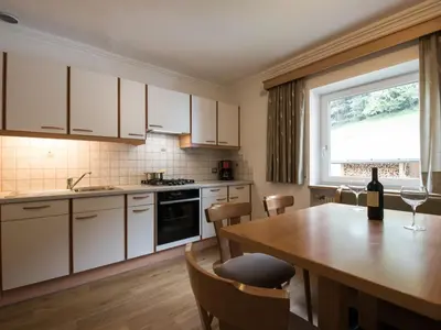 a room with a table and chairs on a balcony at Apartment Ornella-3 by Interhome in Ortisei