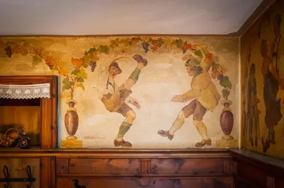 a painting on a wall with two men and vegetables at Kaiserau 1907 in Collalbo