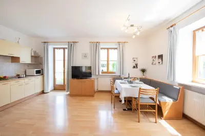 a kitchen and dining room with a table and chairs at Göllerhof in Caldaro