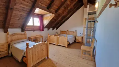 a bedroom with four beds and a ladder at Malga Arpaco- camere e ristorante in Cinte Tesino